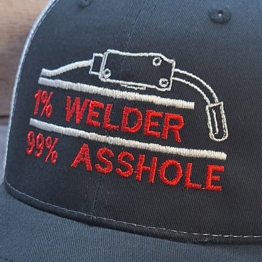 Black and white cap with red and white text on a wooden surface