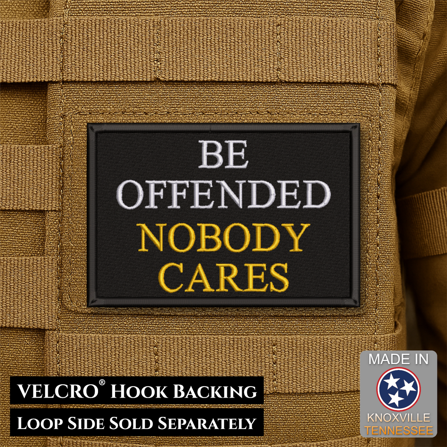 A rectangular black embroidered patch with the text 'BE OFFENDED NOBODY CARES' in white and yellow lettering, shown attached to tan tactical webbing. Text at the bottom notes VELCRO hook backing and loop side sold separately, with a Made in Tennessee badge in the lower right.