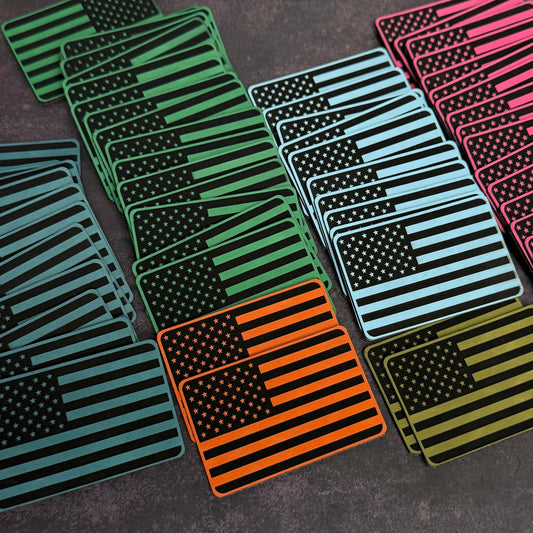 Engraved American flag morale patches with VELCRO hook backing in various colors.