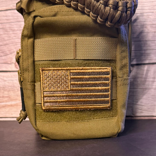 An coyote brown tactical pouch with a US flag patch on the front, featuring a paracord strap at the top, set against a rustic wood background.