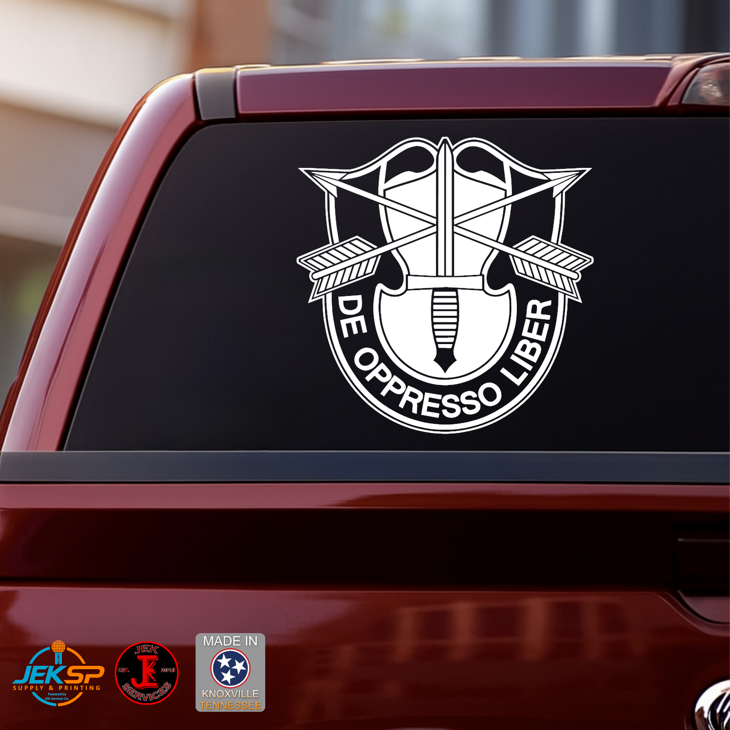 White De Oppresso Liber Special Forces crest vinyl decal displayed on the rear window of a red pickup truck.