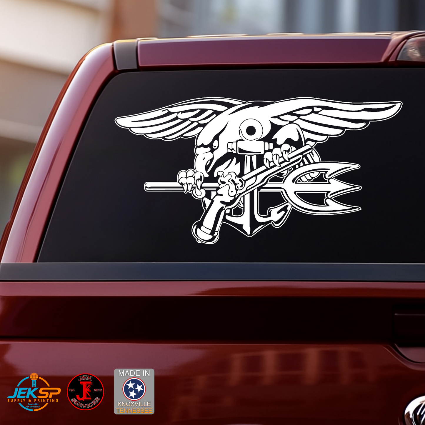 White Navy SEAL Trident Naval Special Warfare vinyl decal displayed on the rear window of a red pickup truck.