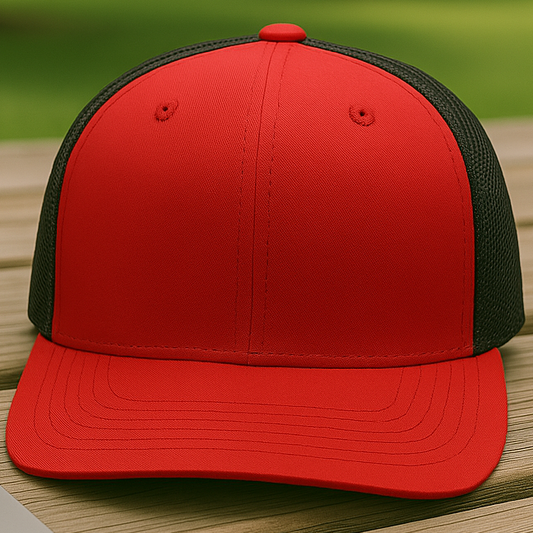 Red and black cap on a wooden surface with a blurred green outdoor background