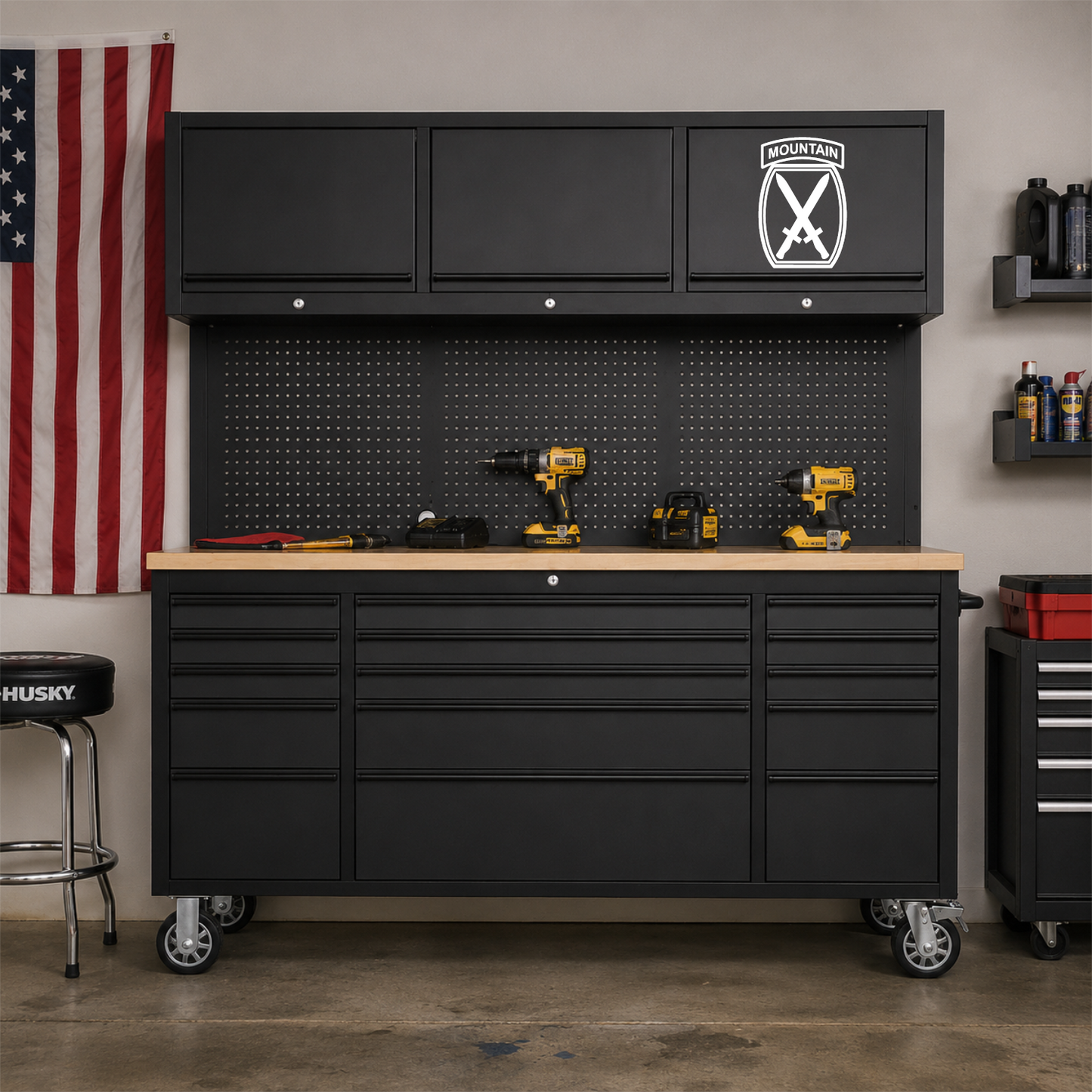 Army 10th Mountain patch vinyl decal on a black tool box in a garage.