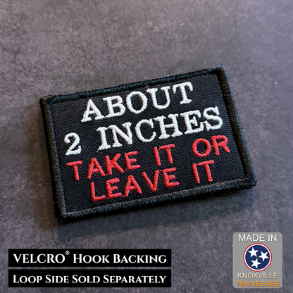 Black embroidered About 2 Inches Take It or Leave It funny morale patch with white and red lettering