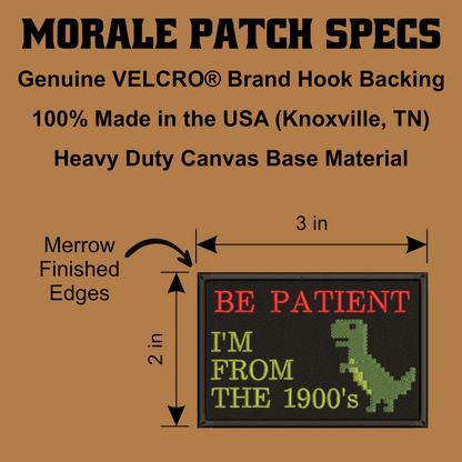 A product specification graphic for a Morale Patch, showing a rectangular embroidered patch with a black background, red and green text reading 'BE PATIENT I'M FROM THE 1900's', and a green pixelated dinosaur. The graphic includes text about VELCRO brand hook backing, 100% made in the USA, and dimensions of 3 in by 2 in, on a tan background.