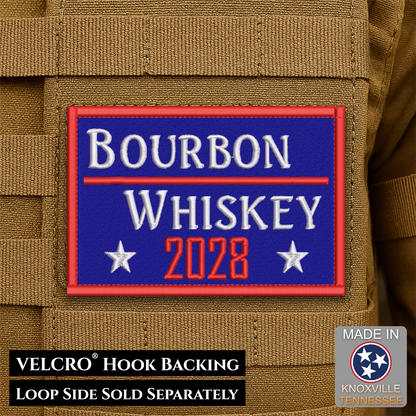 A rectangular embroidered patch reading “Bourbon Whiskey 2028” in white and red on a blue background, shown attached to tan tactical webbing. Text at the bottom says “VELCRO Hook Backing LOOP SIDE SOLD SEPARATELY,” and a “Made in Knoxville Tennessee” badge appears in the lower right.
