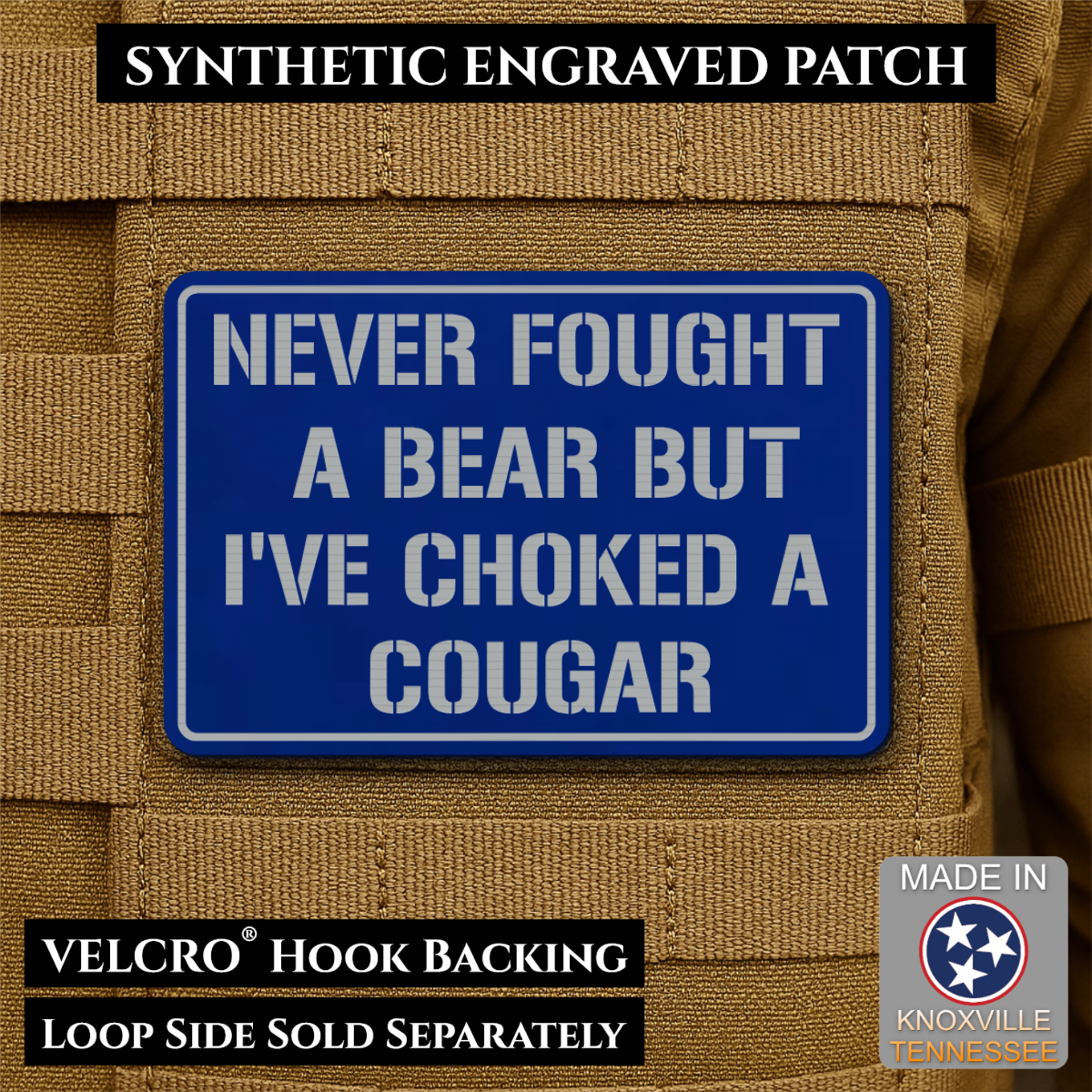 I’ve Choked A Cougar laser-engraved synthetic morale patch: a blue rectangular synthetic engraved patch with white text reading 'NEVER FOUGHT A BEAR BUT I'VE CHOKED A COUGAR,' shown attached to tan tactical vest loops. Black text.