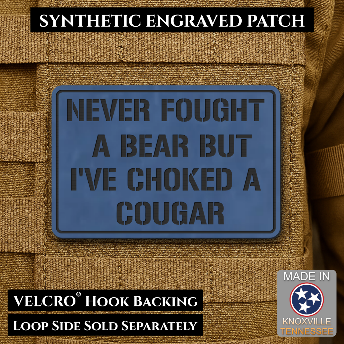 I’ve Choked A Cougar laser-engraved synthetic morale patch: a blue rectangular synthetic engraved patch with black text reading “NEVER FOUGHT A BEAR BUT I’VE CHOKED A COUGAR,” shown attached to tan tactical vest loops. Text banners.