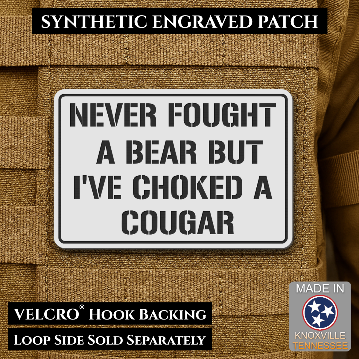 I’ve Choked A Cougar laser-engraved synthetic morale patch: a rectangular synthetic engraved patch with a white background and black border, featuring the text 'NEVER FOUGHT A BEAR BUT I'VE CHOKED A COUGAR' in bold black lettering.