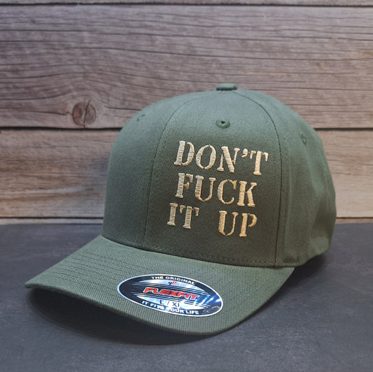 Green cap with 'DON'T FUCK IT UP' text on a wooden background