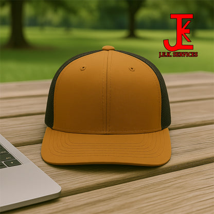 Brown and black cap on a wooden surface with a blurred green outdoor background