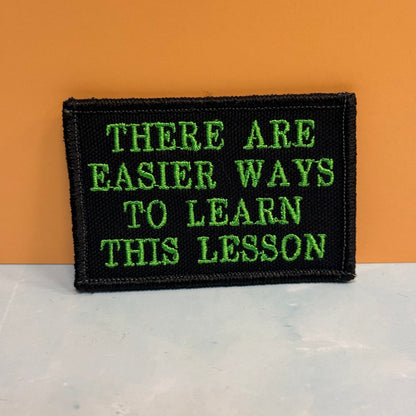 Hard Life Lessons Funny Embroidered Morale Patch, 2x3" | VELCRO® Brand Hook Backing