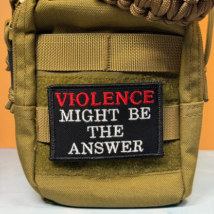 An olive drab tactical pouch with a black embroidered patch that reads 'VIOLENCE MIGHT BE THE ANSWER' in red and white lettering, set against a solid orange background.