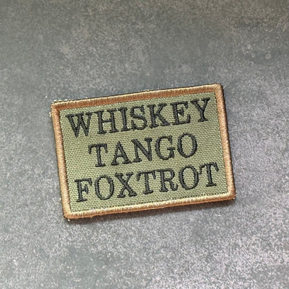 Olive drab Whiskey Tango Foxtrot embroidered morale patch with black lettering and VELCRO hook backing