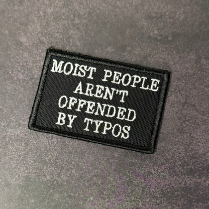Black patch with white text on a gray background