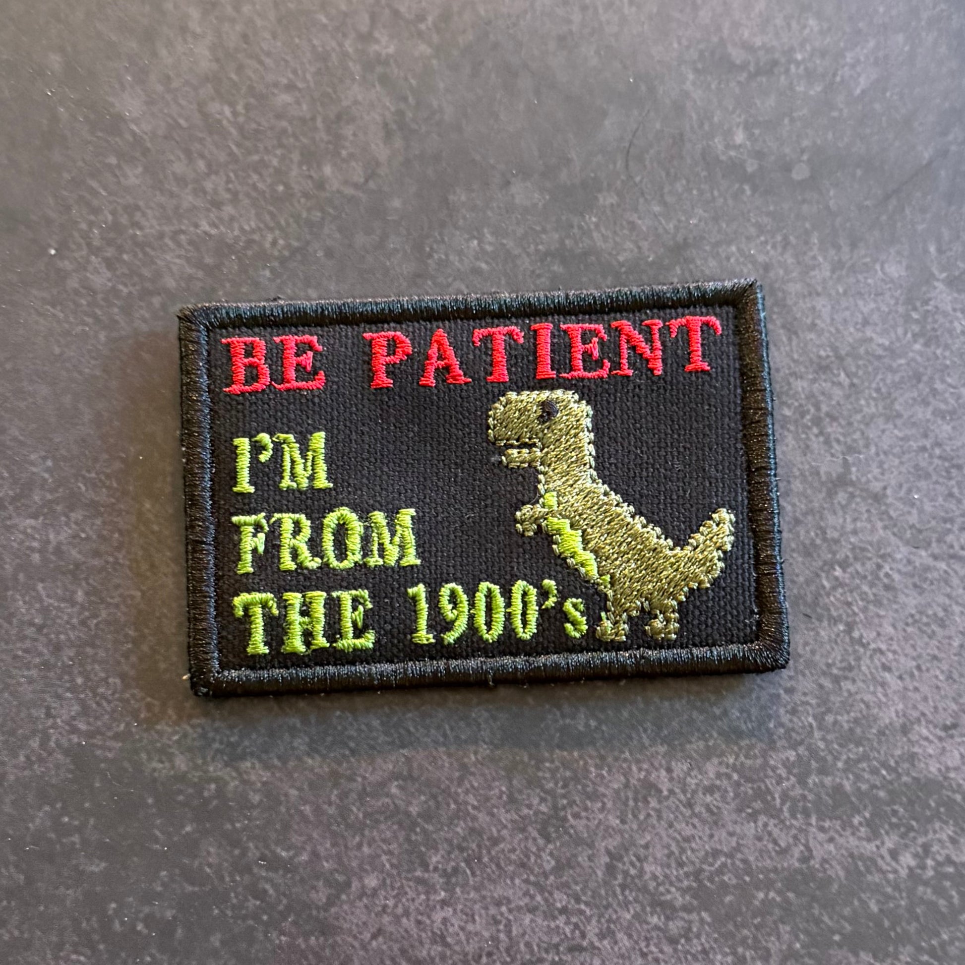 Embroidered Be Patient I'm From The 1900's morale patch featuring a dinosaur graphic and nostalgic humor