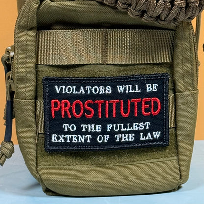 An olive green tactical pouch featuring a black embroidered patch with the text 'VIOLATORS WILL BE PROSTITUTED TO THE FULLEST EXTENT OF THE LAW' in white and red lettering.