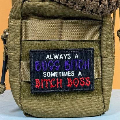 An olive green tactical pouch featuring a black embroidered patch with the text 'ALWAYS A BOSS BITCH SOMETIMES A BITCH BOSS' in white, purple, and red lettering.