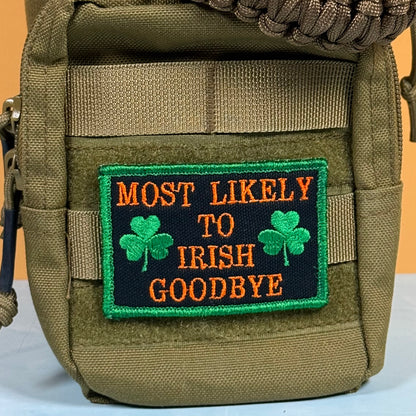 An olive green tactical pouch featuring a rectangular embroidered patch with the text 'MOST LIKELY TO IRISH GOODBYE' in orange on a black background, decorated with two green shamrocks and a green border.