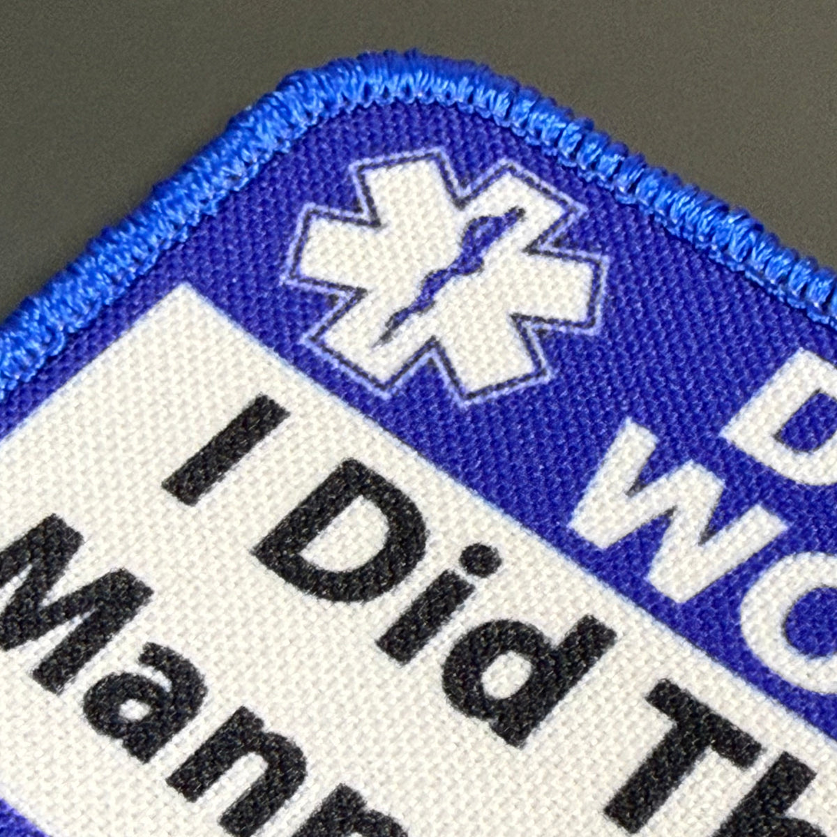 I Did This On a Mannequin Once printed canvas morale patch, close-up of an printed patch with a blue border, white background, black text reading 'I Did The Man.