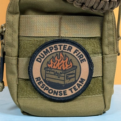 An olive drab tactical pouch featuring a circular embroidered patch that reads 'DUMPSTER FIRE RESPONSE TEAM' with a fire graphic in the center, set against a plain background.