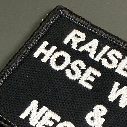Raised on Hose Water & Neglect embroidered morale patch: black embroidered patch with white text reading 'RAISE HOSE W NEC &' on a dark gray background.