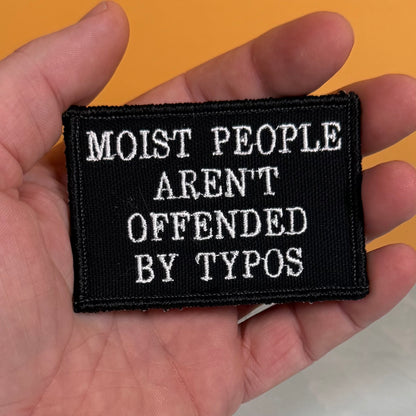 Moist People Aren’t Offended by Typos Funny embroidered morale patch, product photograph.
