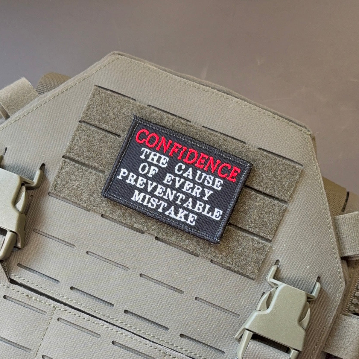 Confidence Causes Mistakes Funny embroidered morale patch, front view.