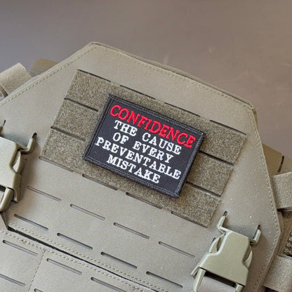 Confidence Causes Mistakes Funny embroidered morale patch, front view.