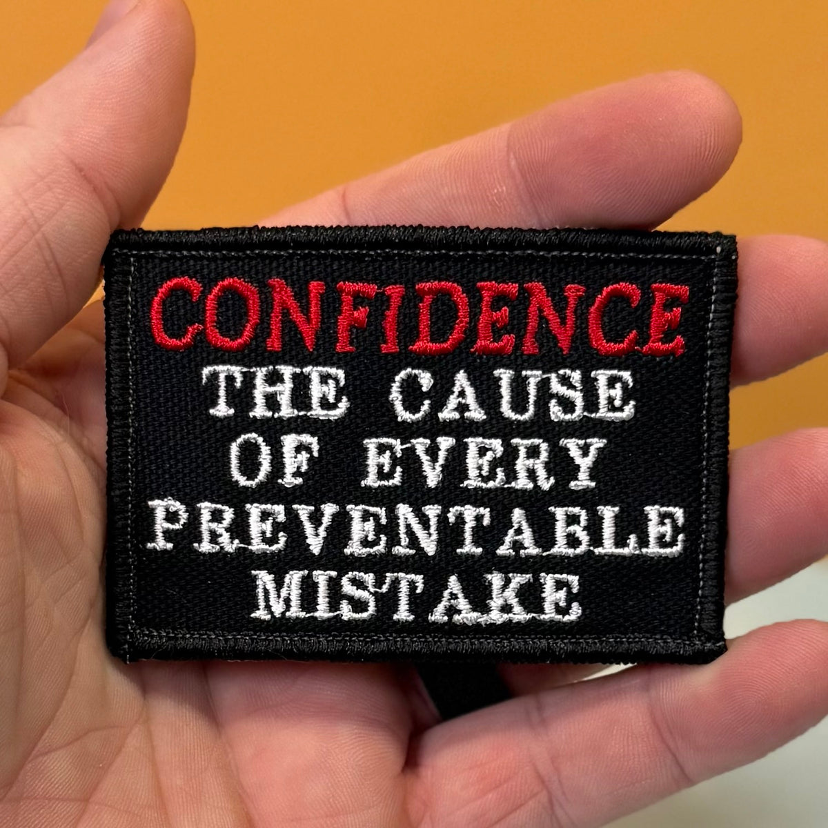Confidence Causes Mistakes Funny embroidered morale patch, product photograph.