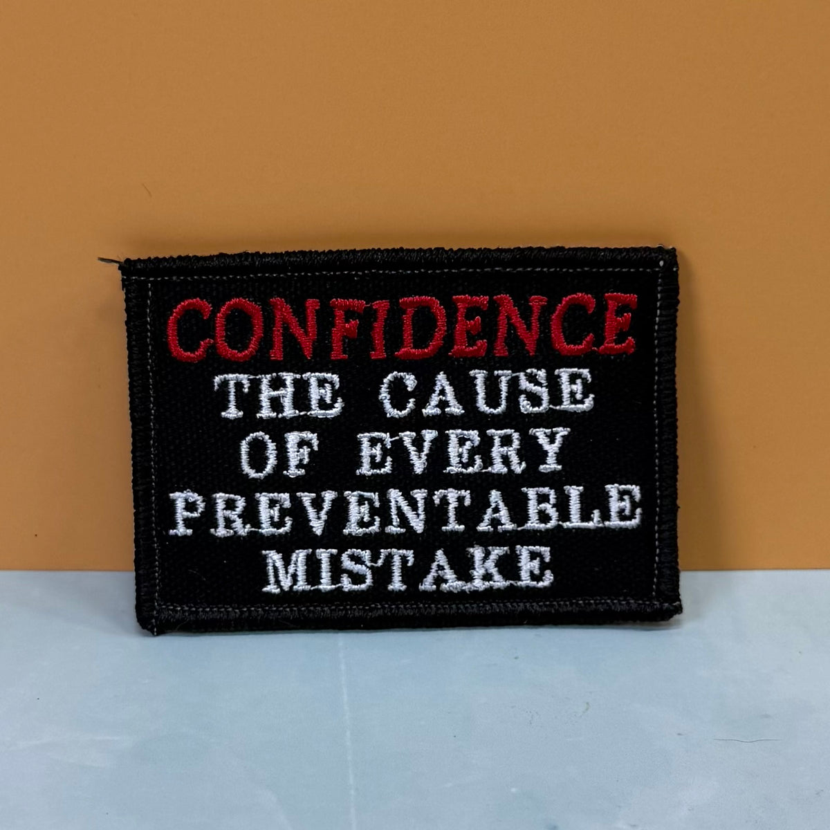 Confidence Causes Mistakes Funny embroidered morale patch, product photograph.