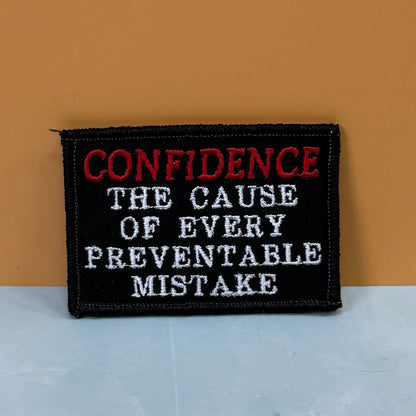 Confidence Causes Mistakes Funny embroidered morale patch, product photograph.