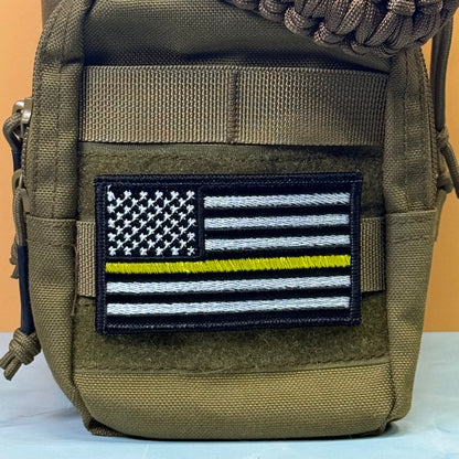 Thin Yellow Line American Flag embroidered morale patch: pouch in olive drab nylon featuring an embroidered 'Thin Blue Line' American flag patch on the front pocket.