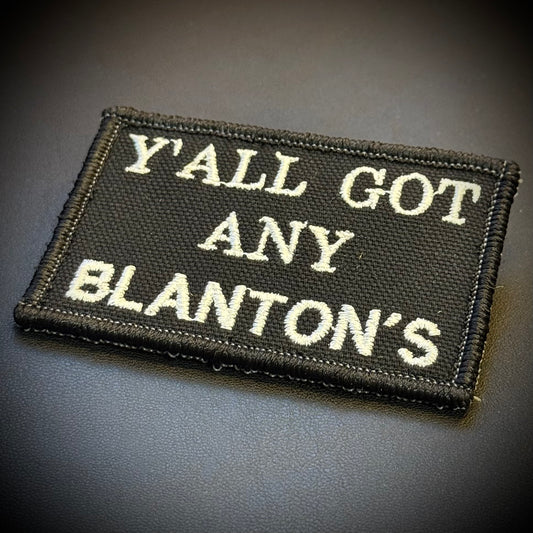 A rectangular black embroidered patch with white text reading 'Y'ALL GOT ANY BLANTON'S' on a dark gray background.