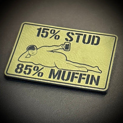 15% Stud 85% Muffin Funny Dad Bod laser-engraved synthetic morale patch: a rectangular novelty patch with rounded corners featuring a black graphic and text on a pale yellow background. The text reads '15% STUD' at the top and '85%.