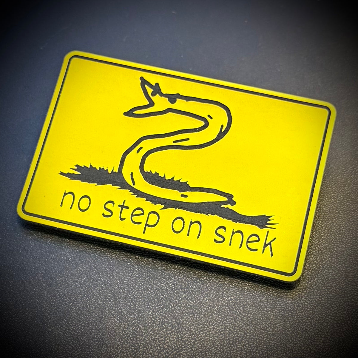 No Step On Snek laser-engraved synthetic morale patch, front view.