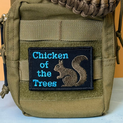 Squirrel, Chicken of the Trees embroidered morale patch: olive green tactical pouch featuring a black embroidered patch with the text 'Chicken of the Trees' in blue and a brown squirrel illustration.