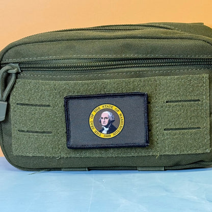 Washington State Flag printed canvas morale patch, an olive green tactical pouch with a black rectangular patch featuring a circular US States of Virginia design with George Washington's portrait.