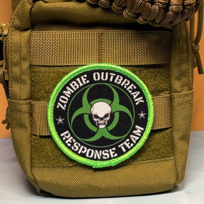 Zombie Outbreak Response Team printed canvas morale patch, the design lettering with a skull and biohazard symbol, attached to an olive drab MOLLE pouch.