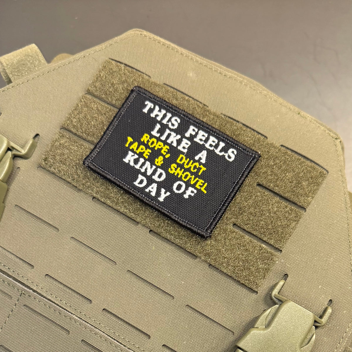 This Feels Like A Rope & Duct Tape Kind Of Day embroidered morale patch: black rectangular embroidered patch with white and yellow text reading 'THIS FEELS LIKE A KNOB OF DAY' mounted on tan tactical gear with Velcro strips.