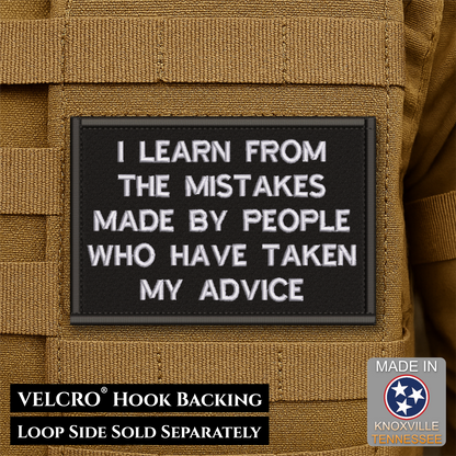 A rectangular black Velcro patch with white embroidered text reading 'I LEARN FROM THE MISTAKES MADE BY PEOPLE WHO HAVE TAKEN MY ADVICE,' shown attached to tan tactical webbing. Text at the bottom says 'VELCRO HOOK BACKING LOOP SIDE SOLD SEPARATELY,' and a 'Made in Knoxville Tennessee' badge appears in the lower right.