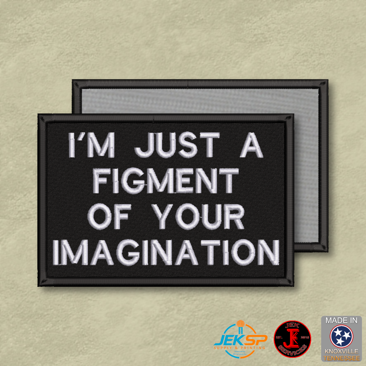 I'm Just a Figment of Your Imagination embroidered funny morale patch with black background, white stitched lettering, genuine hook backing, and gray loop panel displayed behind.