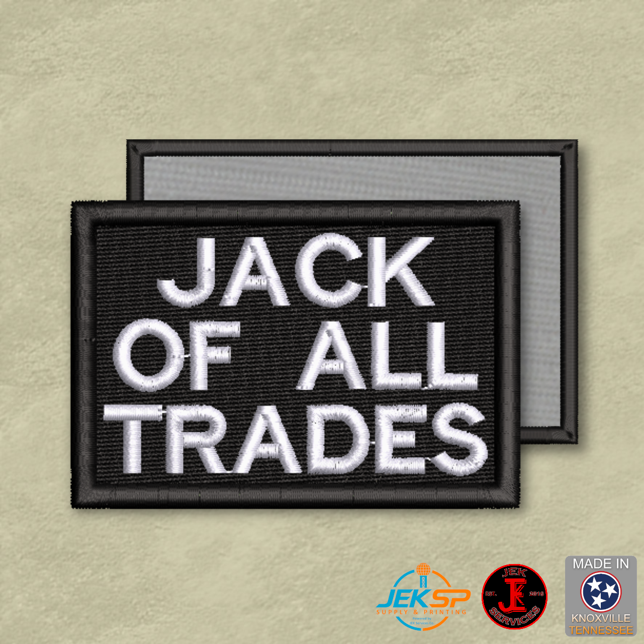 Black embroidered "Jack of All Trades" morale patch with white lettering, genuine VELCRO® hook backing, made in Tennessee.