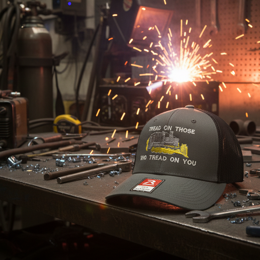 Black cap with text on a workshop table with sparks and tools