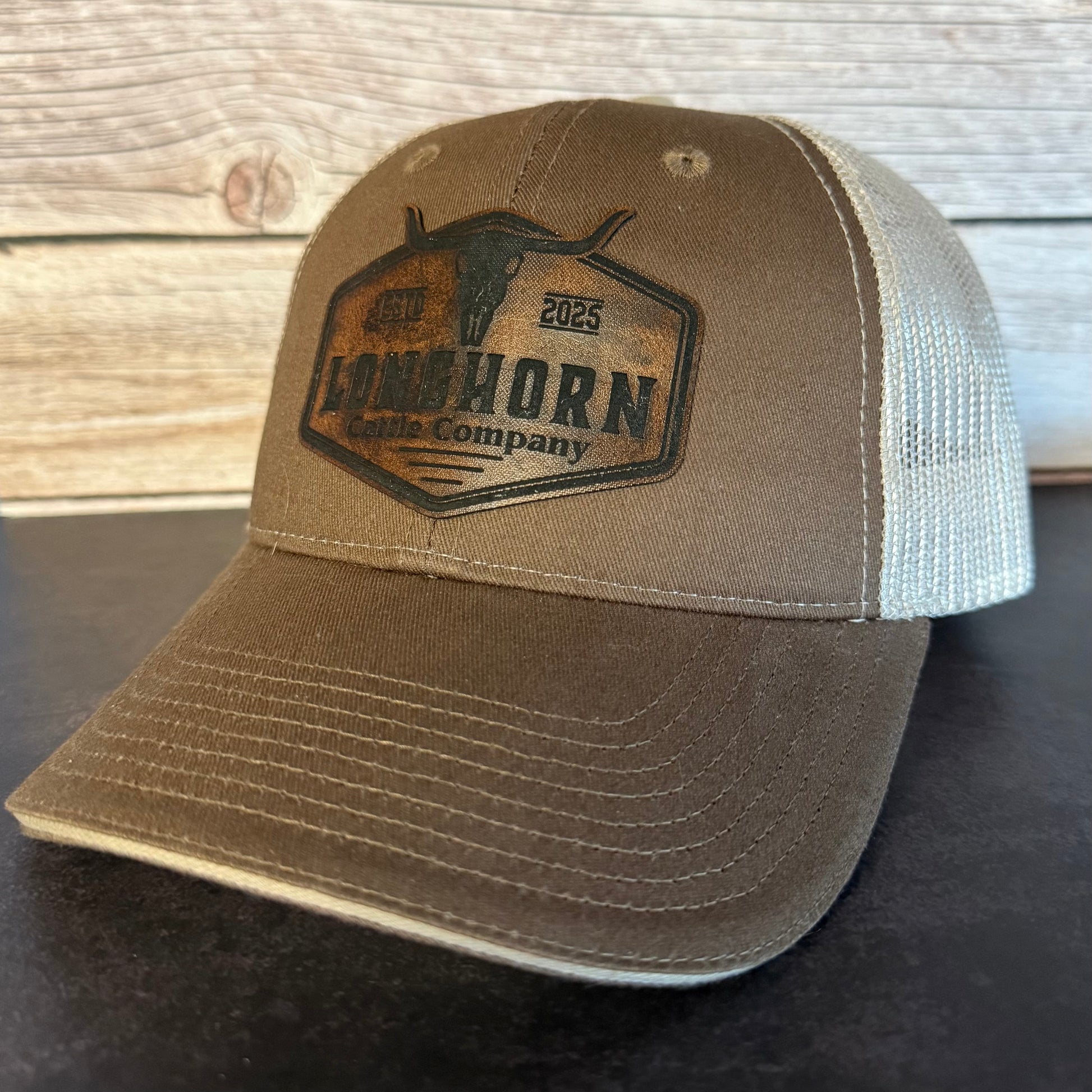 Brown cap with a leather-like patch on a wooden surface