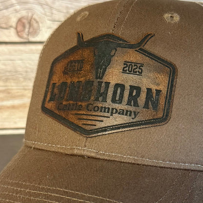 Brown cap with a leather-like patch on a wooden surface