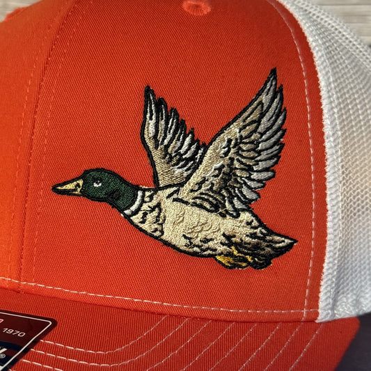 Orange cap with a flying duck design on a white background