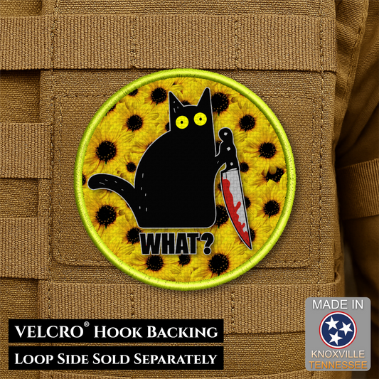 Patch with a black cat holding a knife on a yellow background, featuring text and a VELCRO hook backing label.