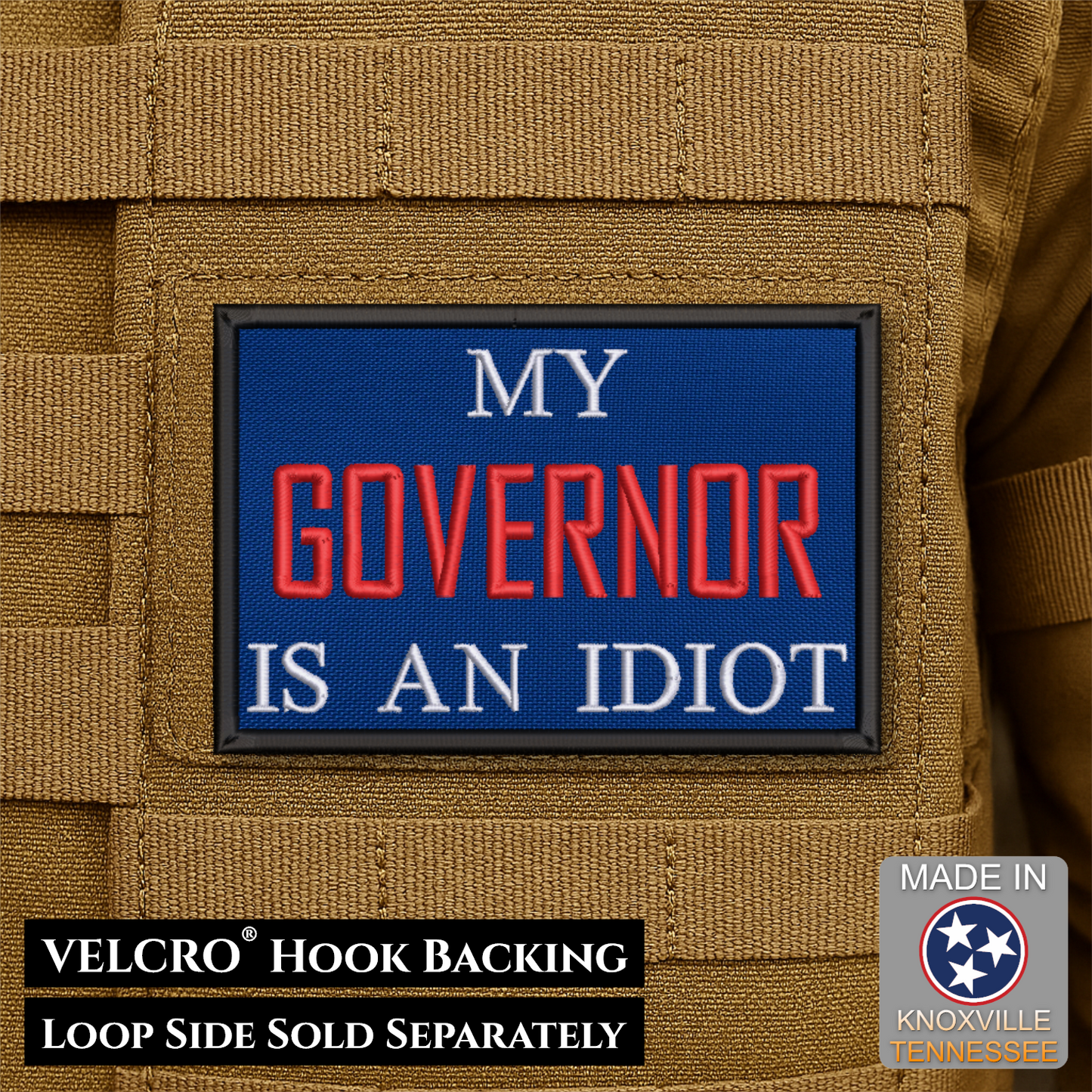 A rectangular embroidered patch with a blue background and the text 'MY GOVERNOR IS AN IDIOT' in white and red lettering, shown attached to tan tactical gear. Black text at the bottom reads 'VELCRO HOOK BACKING LOOP SIDE SOLD SEPARATELY,' and a 'Made in Knoxville Tennessee' badge appears in the lower right.